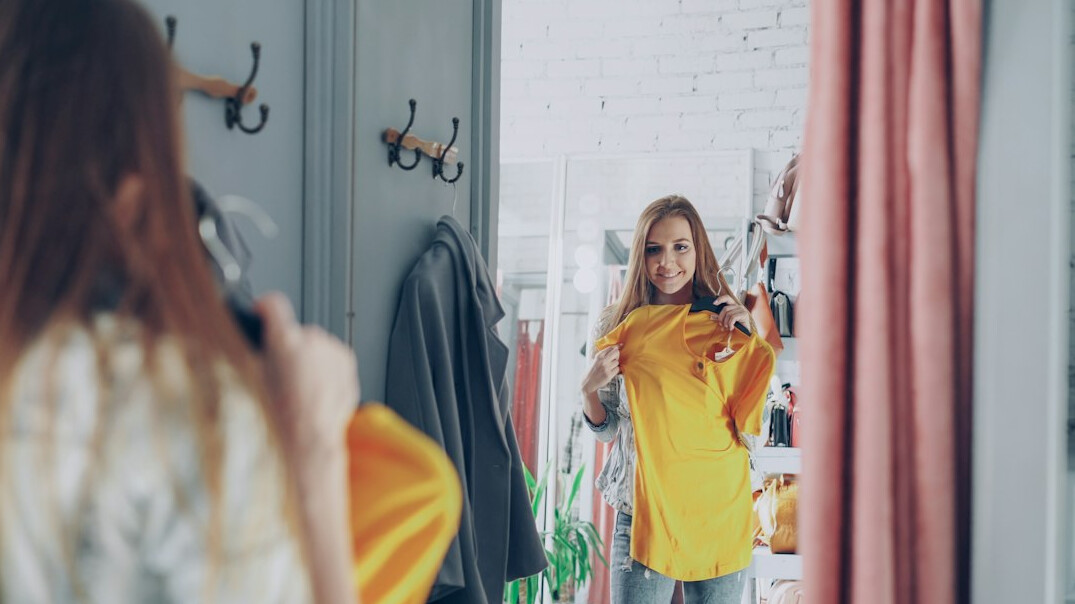 woman trying on clothes in store